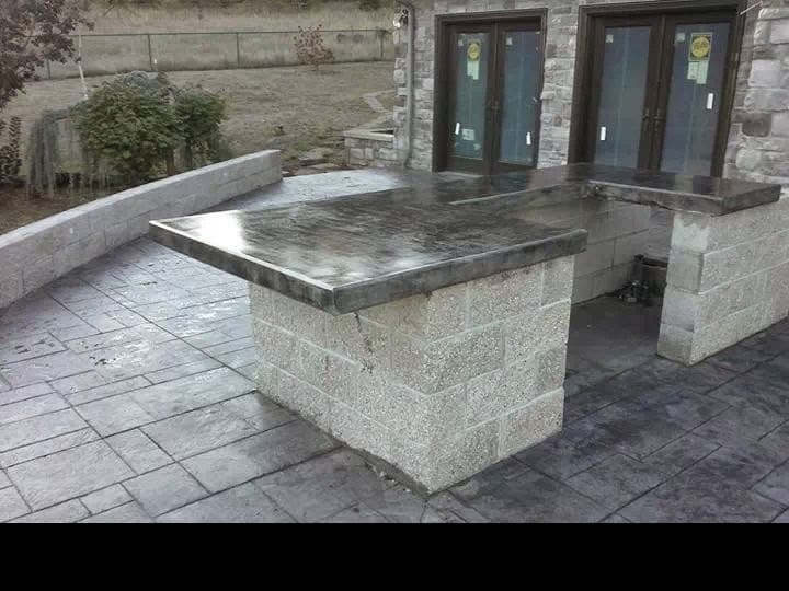 Outdoor kitchen with exposed aggregate flooring
